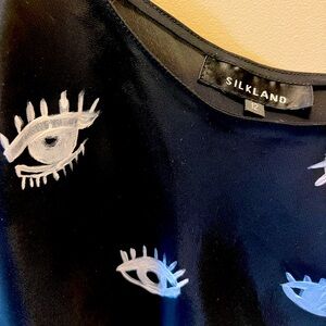 Black silky tank with eyelash print